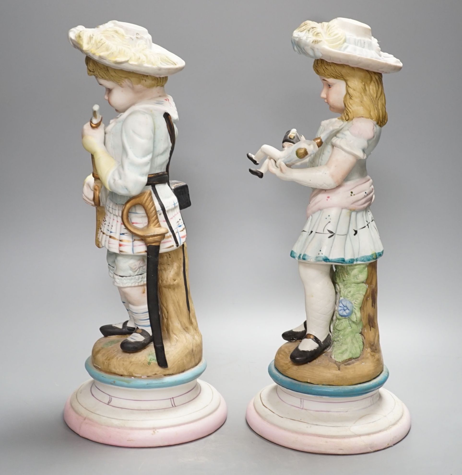 A pair of Continental coloured bisque figures of children - 39cm high